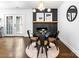 Elegant dining room with modern light fixture, brick fireplace and hardwood floors at 5825 Ruth Dr, Charlotte, NC 28215
