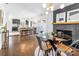 Open floor plan features a modern dining room with a glass table, black brick fireplace and an open kitchen at 5825 Ruth Dr, Charlotte, NC 28215