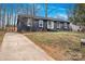 Charming single-story home featuring a dark painted brick facade, inviting entrance and well-manicured lawn at 5825 Ruth Dr, Charlotte, NC 28215
