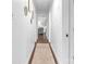 Hallway with neutral runner, white trim and paint with views to a living room at 5825 Ruth Dr, Charlotte, NC 28215
