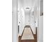 Hallway with neutral runner, white trim and paint with views to a bathroom and bedrooms at 5825 Ruth Dr, Charlotte, NC 28215