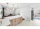 Open-concept kitchen with a large island with light wood colored cabinets, white countertops and modern floors at 5825 Ruth Dr, Charlotte, NC 28215