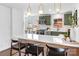Eat-in kitchen with bright white countertops, trendy green cabinetry and stainless appliances and tiled floors at 5825 Ruth Dr, Charlotte, NC 28215