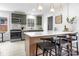 Open kitchen features an eat-in island, stainless appliances, green cabinets and stylish tiled floors at 5825 Ruth Dr, Charlotte, NC 28215