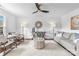 Bright living room featuring hardwood floors, neutral paint, with modern furnishings, and a decorative ceiling fan at 5825 Ruth Dr, Charlotte, NC 28215