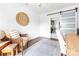 Home office boasts hardwood floors, neutral paint, a barn door to the kitchen and a cozy seating area at 5825 Ruth Dr, Charlotte, NC 28215