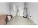 Clean utility room with gray patterned tile flooring and neutral paint at 5825 Ruth Dr, Charlotte, NC 28215
