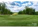 Scenic golf course view with manicured green and mature trees on a sunny day at 6044 Great Basin Ln, Fort Mill, SC 29707
