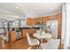 Spacious kitchen with stainless steel appliances, wooden cabinets, and an adjacent dining area at 6044 Great Basin Ln, Fort Mill, SC 29707