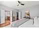 Light and bright main bedroom with hardwood floors, a ceiling fan, and a private bathroom at 6044 Great Basin Ln, Fort Mill, SC 29707