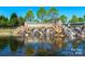 Picturesque waterfall feature at Sun City Carolina Lakes with stone accents and lush landscaping at 6044 Great Basin Ln, Fort Mill, SC 29707