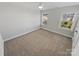 Spacious bedroom with neutral carpet, ceiling fan, and two bright windows at 6234 Artigas Dr, Fort Mill, SC 29707