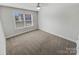Bright bedroom featuring neutral carpet and a large window with natural light at 6234 Artigas Dr, Fort Mill, SC 29707