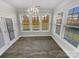 Bright dining room with hardwood floors, a modern chandelier, and large windows at 6234 Artigas Dr, Fort Mill, SC 29707