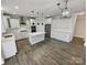 Modern kitchen featuring white cabinets, stainless appliances, and a large island with pendant lighting at 6234 Artigas Dr, Fort Mill, SC 29707