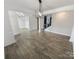 Open-concept living room with hardwood floors, modern light fixture, and staircase to the second floor at 6234 Artigas Dr, Fort Mill, SC 29707