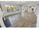 Spacious living room with hardwood floors, large windows, and an open view to the kitchen at 6234 Artigas Dr, Fort Mill, SC 29707