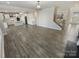 Open-concept living room with hardwood floors and a modern kitchen featuring white cabinets and stainless appliances at 6234 Artigas Dr, Fort Mill, SC 29707
