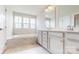 Bright bathroom with double vanity, soaking tub and marble flooring at 730 Autumn Sage Dr, Indian Trail, NC 28079