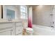 Well-lit bathroom with white cabinets, tiled walls, and shower-tub combination at 730 Autumn Sage Dr, Indian Trail, NC 28079