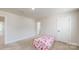 Cozy bedroom with patterned bedspread and neutral carpet at 730 Autumn Sage Dr, Indian Trail, NC 28079