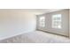 Bright bedroom with neutral carpet and two windows letting in natural light at 730 Autumn Sage Dr, Indian Trail, NC 28079
