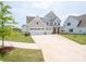 Charming two-story home featuring a three-car garage and covered front porch at 730 Autumn Sage Dr, Indian Trail, NC 28079