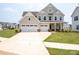 Charming two-story home featuring a three-car garage and covered front porch at 730 Autumn Sage Dr, Indian Trail, NC 28079