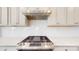 Modern kitchen featuring stainless steel range hood and backsplash at 730 Autumn Sage Dr, Indian Trail, NC 28079
