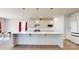 Bright kitchen with large island, white cabinets, stainless steel appliances, and modern lighting at 730 Autumn Sage Dr, Indian Trail, NC 28079