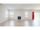 Open-concept living space featuring wood flooring, a fireplace, and ample windows at 730 Autumn Sage Dr, Indian Trail, NC 28079