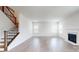 Bright living room with hardwood floors, fireplace, and staircase at 730 Autumn Sage Dr, Indian Trail, NC 28079