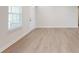 Bright living room with hardwood floors, a large window, and a white door at 730 Autumn Sage Dr, Indian Trail, NC 28079