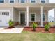 Charming front porch featuring stone accents, landscaping, and a welcoming entrance at 730 Autumn Sage Dr, Indian Trail, NC 28079