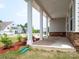 Inviting front porch with white columns and stone accents, perfect for relaxing outdoors at 730 Autumn Sage Dr, Indian Trail, NC 28079