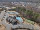 Aerial view of community amenities with pools, tennis courts, and beautiful landscaping at 82116 Standing Oak Dr, Charlotte, NC 28278
