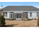 Well-maintained backyard with manicured lawn, covered outdoor seating, and white siding at 82116 Standing Oak Dr, Charlotte, NC 28278
