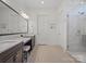 Spacious bathroom featuring double vanities, a glass shower, and modern finishes at 82116 Standing Oak Dr, Charlotte, NC 28278