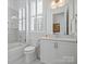 Bright bathroom with a glass-enclosed shower, vanity, and toilet at 82116 Standing Oak Dr, Charlotte, NC 28278