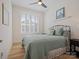 Cozy bedroom featuring a comfortable bed, window shutters, and decorative artwork at 82116 Standing Oak Dr, Charlotte, NC 28278