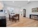 Bright dining room with wood floors, a large window, and a classic dining table at 82116 Standing Oak Dr, Charlotte, NC 28278