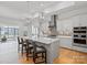 Modern kitchen with a large island, stainless steel appliances, gray cabinets, and stylish pendant lighting at 82116 Standing Oak Dr, Charlotte, NC 28278