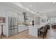 Bright and modern kitchen with stainless steel appliances, gray cabinetry, and a large center island with seating at 82116 Standing Oak Dr, Charlotte, NC 28278