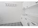 Bright laundry room with patterned tile flooring and white cabinets at 82116 Standing Oak Dr, Charlotte, NC 28278
