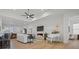 Open-concept living room featuring hardwood floors, fireplace, and a white baby grand piano at 82116 Standing Oak Dr, Charlotte, NC 28278