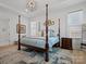 Luxurious bedroom with a four-poster bed, elegant rug, and tray ceiling at 82116 Standing Oak Dr, Charlotte, NC 28278