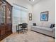Cozy home office featuring a comfortable couch, desk, hutch, and a large window at 82116 Standing Oak Dr, Charlotte, NC 28278