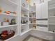 Organized walk-in pantry featuring white shelving and cabinets for ample storage space at 82116 Standing Oak Dr, Charlotte, NC 28278
