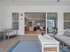 Covered patio with modern furniture, ceiling fan, and a clear view into the home's open floor plan at 82116 Standing Oak Dr, Charlotte, NC 28278