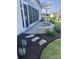 Charming outdoor patio features stone accents, lush greenery, and a covered seating area at 82116 Standing Oak Dr, Charlotte, NC 28278